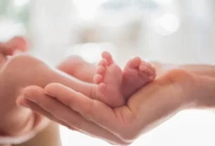 Mother Cradling Newborn Babys Feet